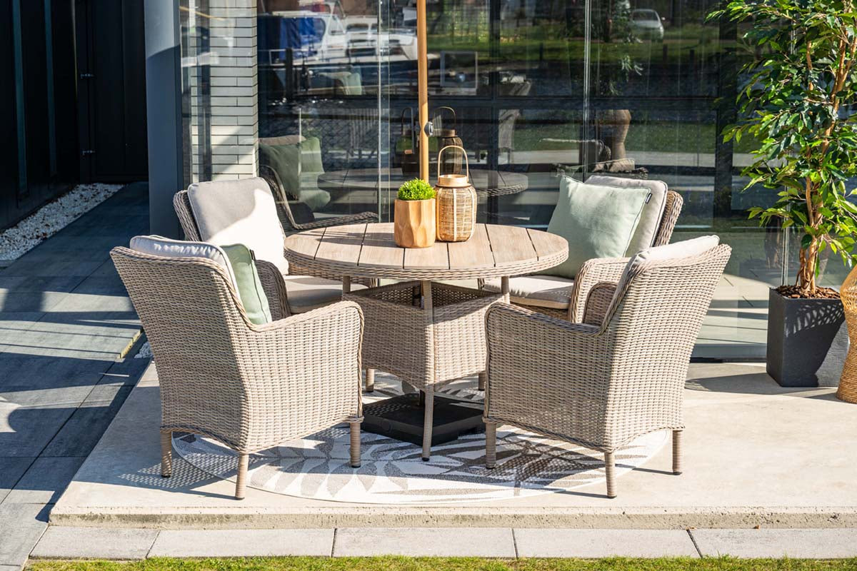 Outdoor patio set with table and chairs on a patio area.