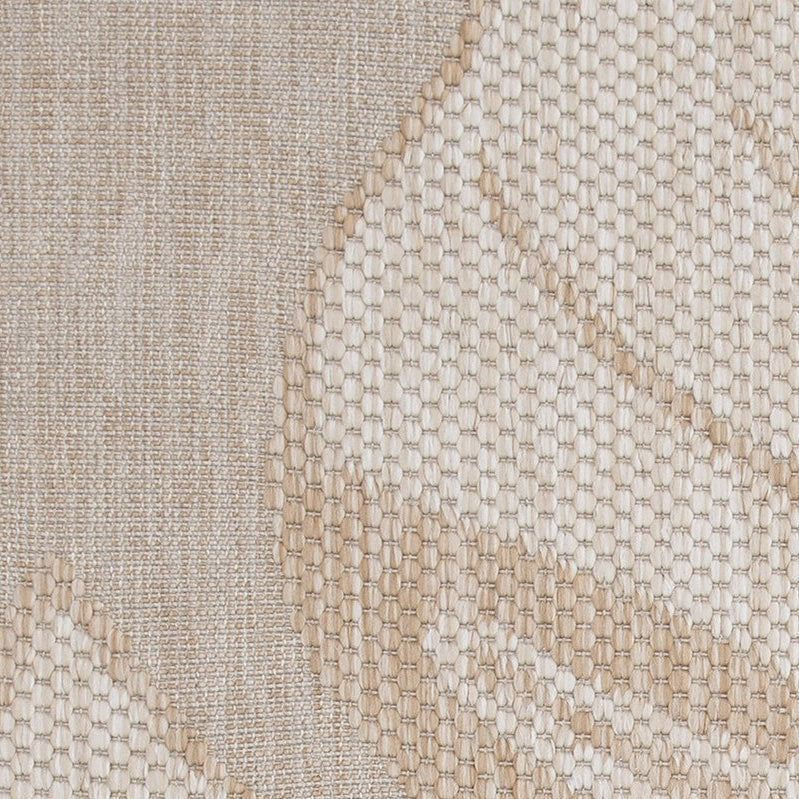 Beige and white leaf patterned rug on a neutral background