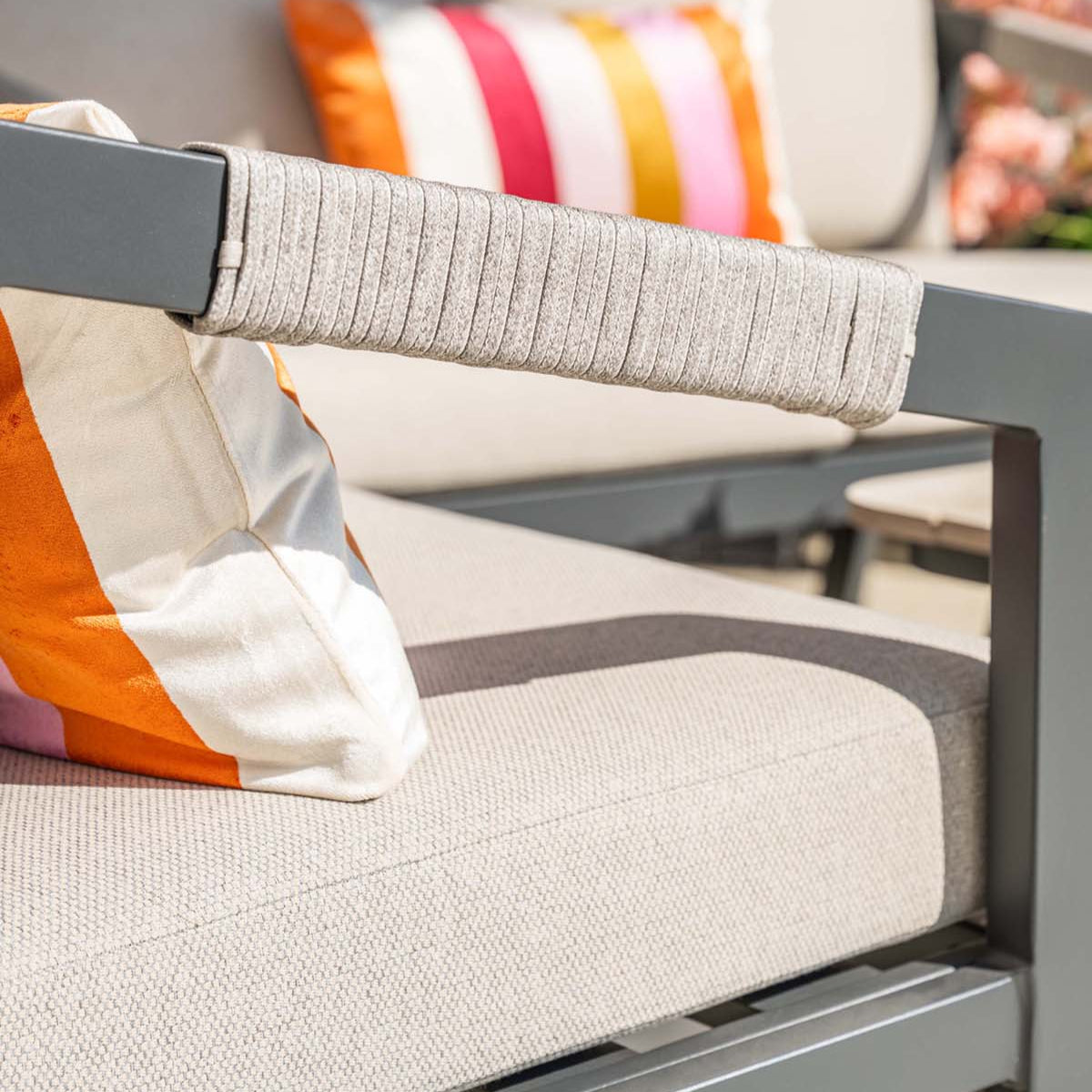 Outdoor furniture with striped cushions and a blurred background