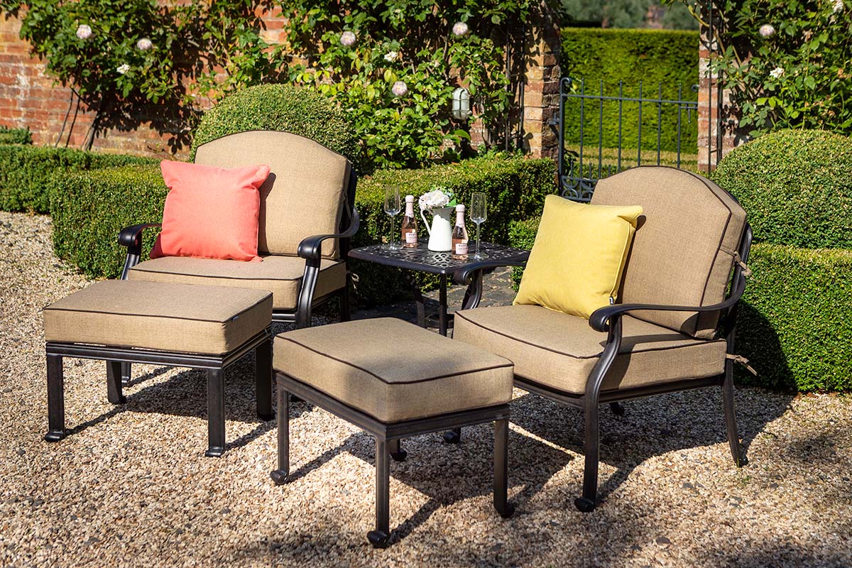 Outdoor patio furniture set with cushions in a garden setting