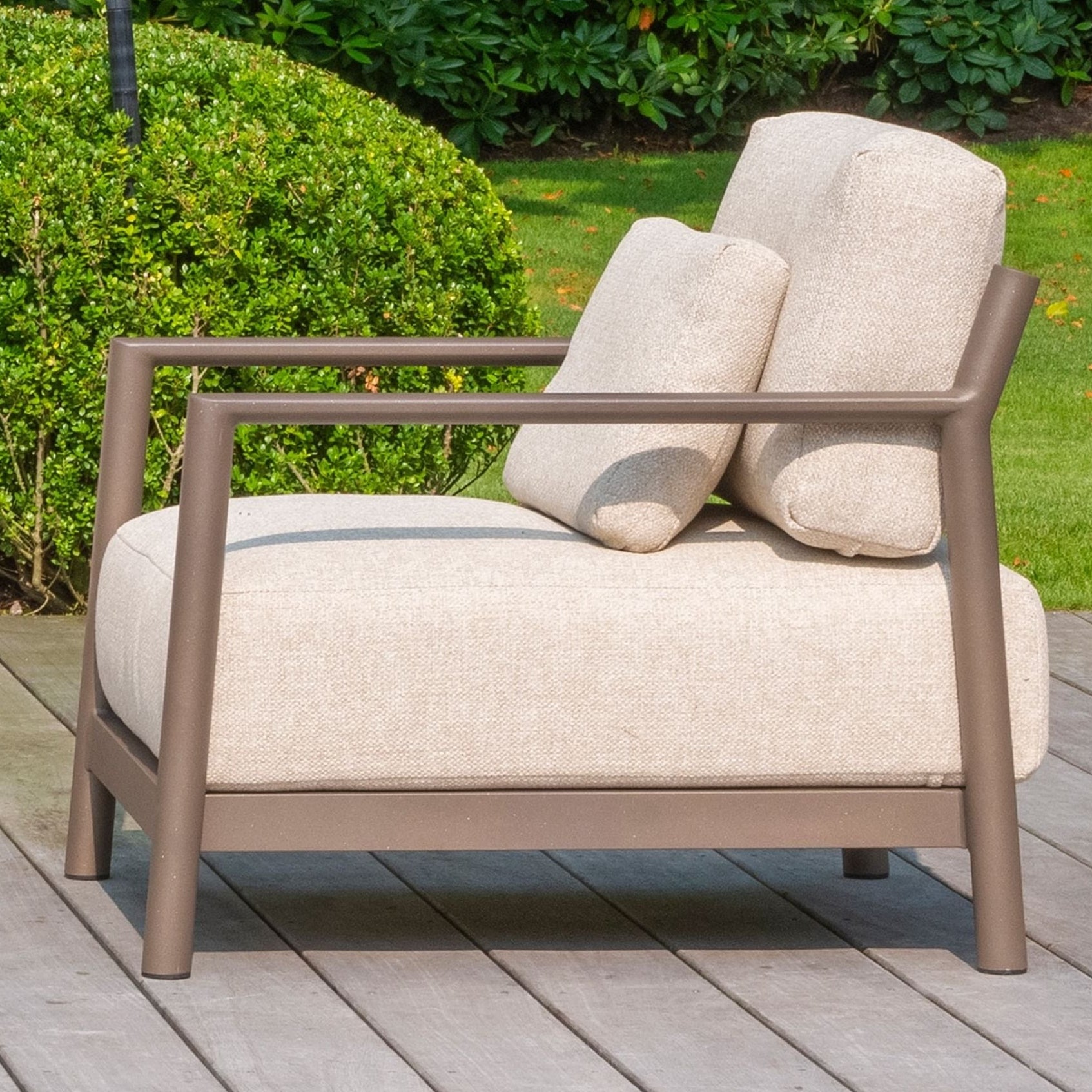 Beige outdoor chair with brown frame on a wooden deck