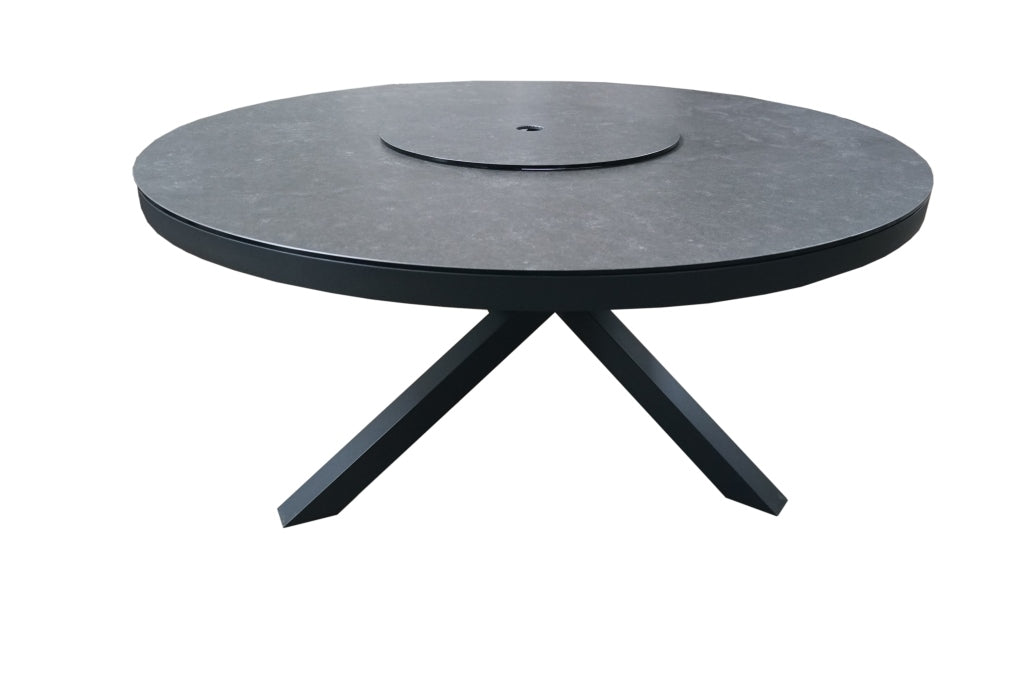 Round black table with a textured surface on a white background