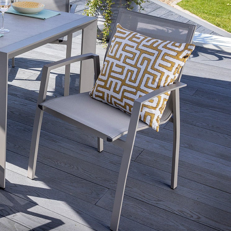 Outdoor dining set with table and chairs on a wooden deck